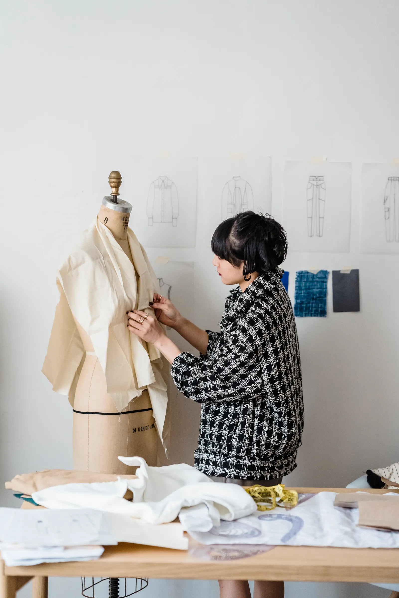 Apparel designer refining a jacket sample on a dress form