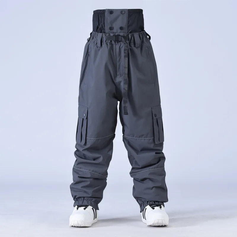 Unisex baggy snowboard pants in Dark Grey — baggy fit with cargo pockets and reflective trim, worn by a model