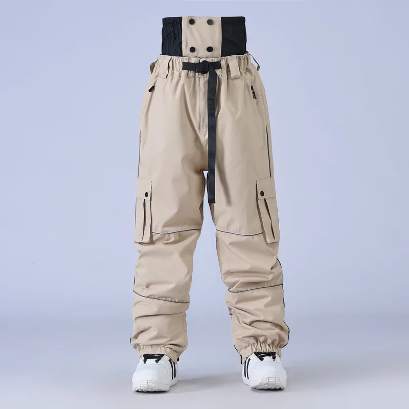 Unisex baggy snowboard pants in Khaki — baggy fit with cargo pockets and reflective trim, worn by a model