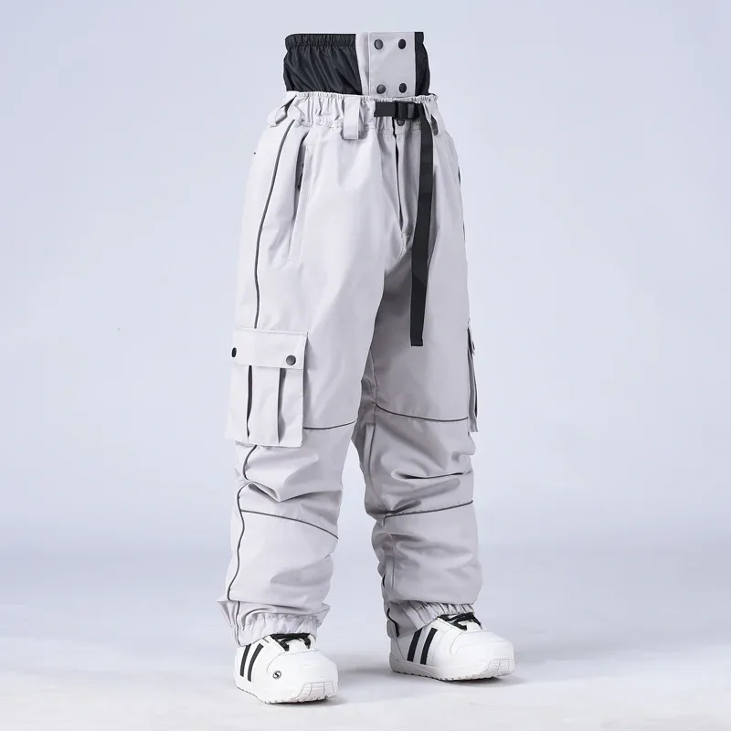 Unisex baggy snowboard pants in Light Grey — baggy fit with cargo pockets and reflective trim, worn by a model