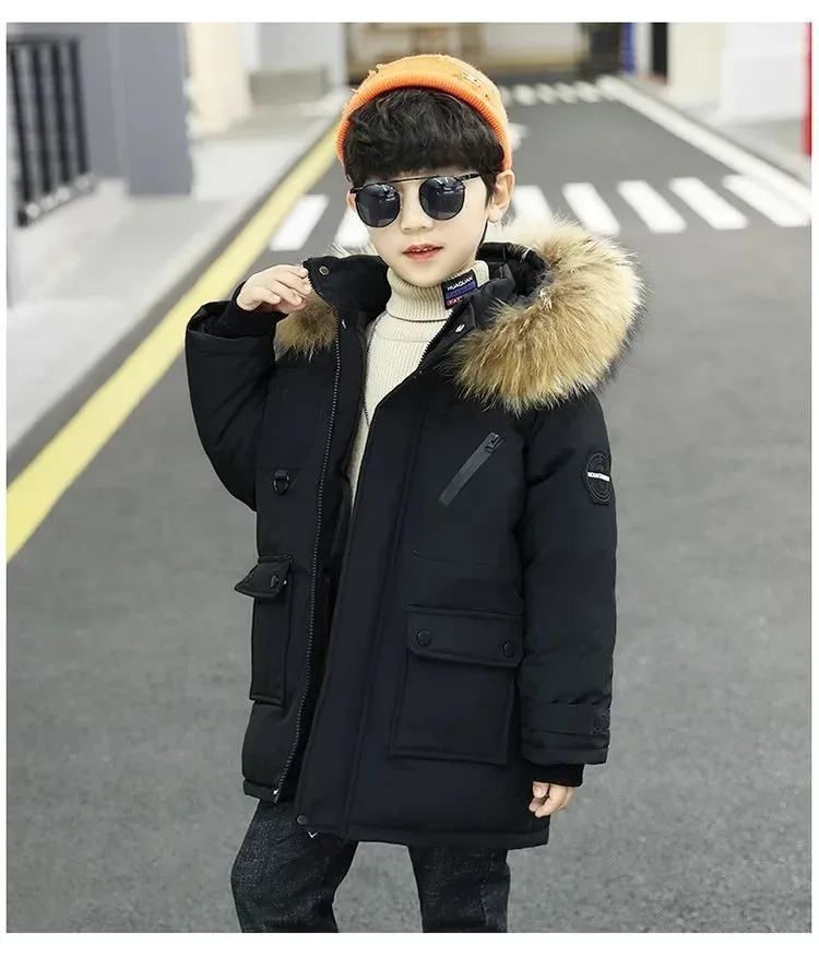 Boys' Mid-Length Parka — Faux-Fur Hood — Black, worn, adjusting the hood
