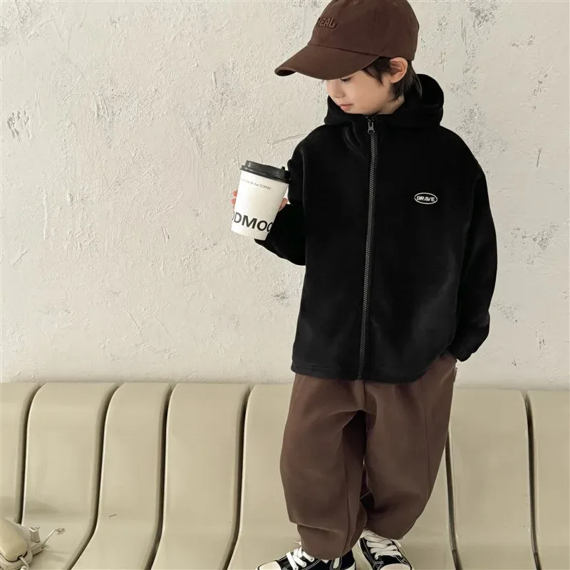 Boys' Zip Fleece Jacket — Black, worn, holding a cup