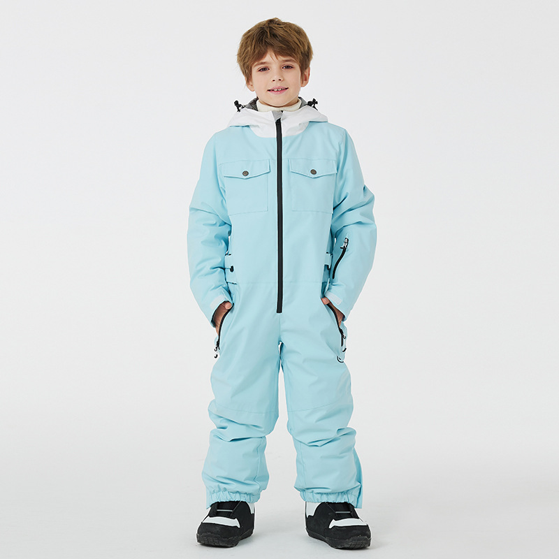 Boy wearing the ice blue one-piece ski jumpsuit with snap-flap chest pockets and an adjustable waist buckle, front view