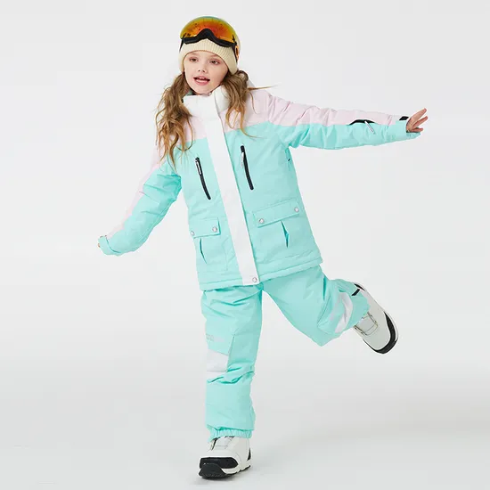 Girl wearing the mint and pink colour-block ski jacket and pants set, mid-jump