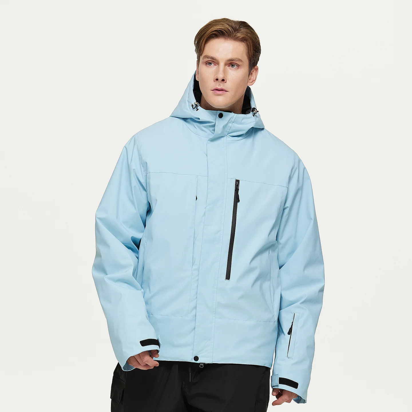 Man wearing the men’s insulated ski jacket in Light Blue with PP cotton fill and an attached hood