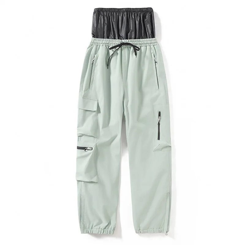Adults’ insulated ski pants in Apple Green — relaxed fit with cargo pockets and an elastic drawcord waist, flat lay