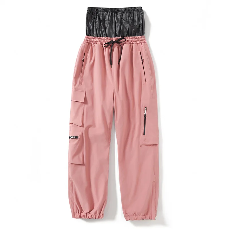 Adults’ insulated ski pants in Brick Red — relaxed fit with cargo pockets and an elastic drawcord waist, flat lay