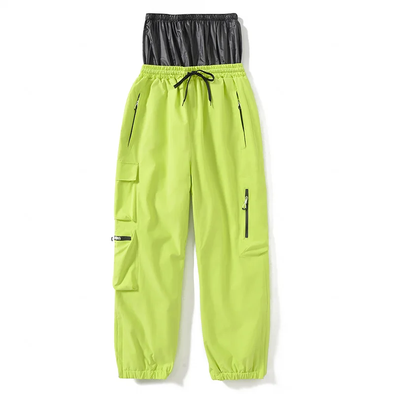Adults’ insulated ski pants in Grass Green — relaxed fit with cargo pockets and an elastic drawcord waist, flat lay