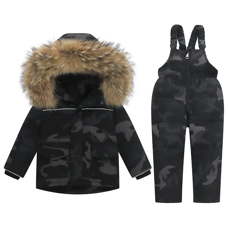 Toddler two-piece ski set in a grey-green camo print — insulated jacket with faux-fur trimmed hood and matching bib pants