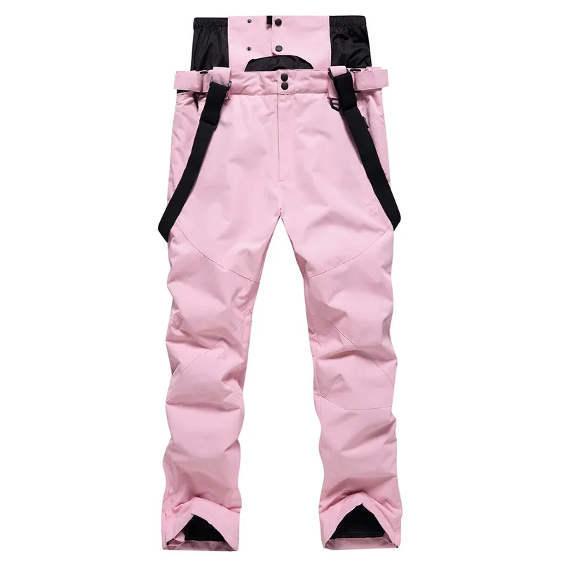 Unisex ski bib pants in Light Pink — adjustable suspenders and a relaxed leg, flat lay