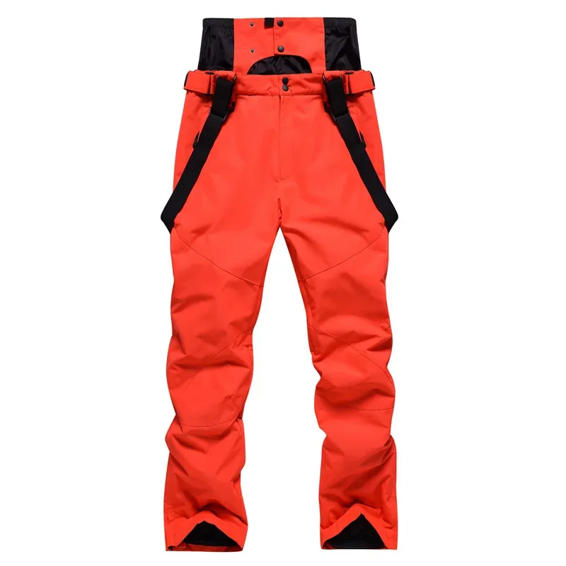 Unisex ski bib pants in Orange — adjustable suspenders and a relaxed leg, flat lay