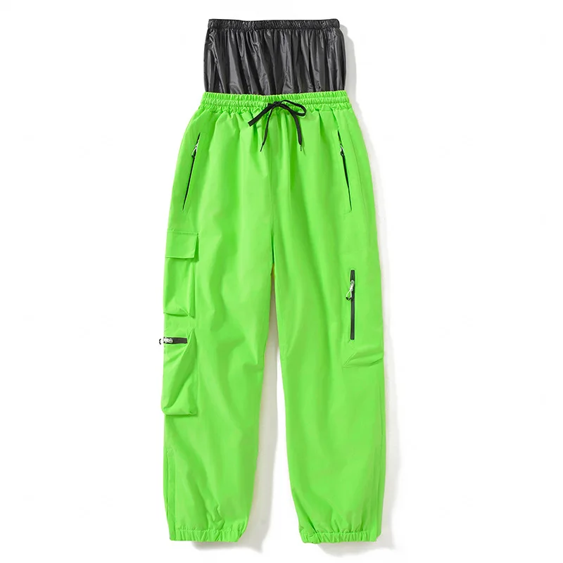 Unisex insulated ski pants in Green — relaxed fit with cargo pockets and an elastic drawcord waist, flat lay