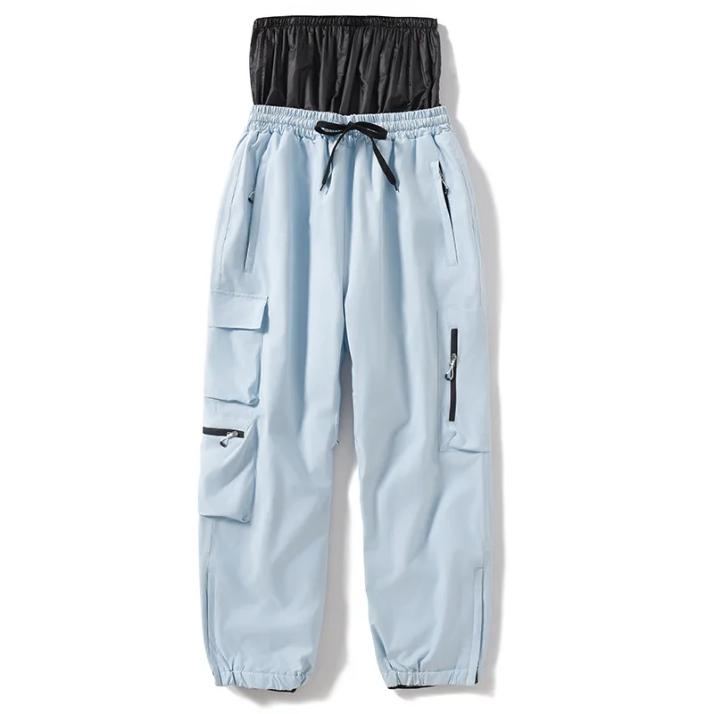 Unisex insulated ski pants in Light Blue — relaxed fit with cargo pockets and an elastic drawcord waist, flat lay
