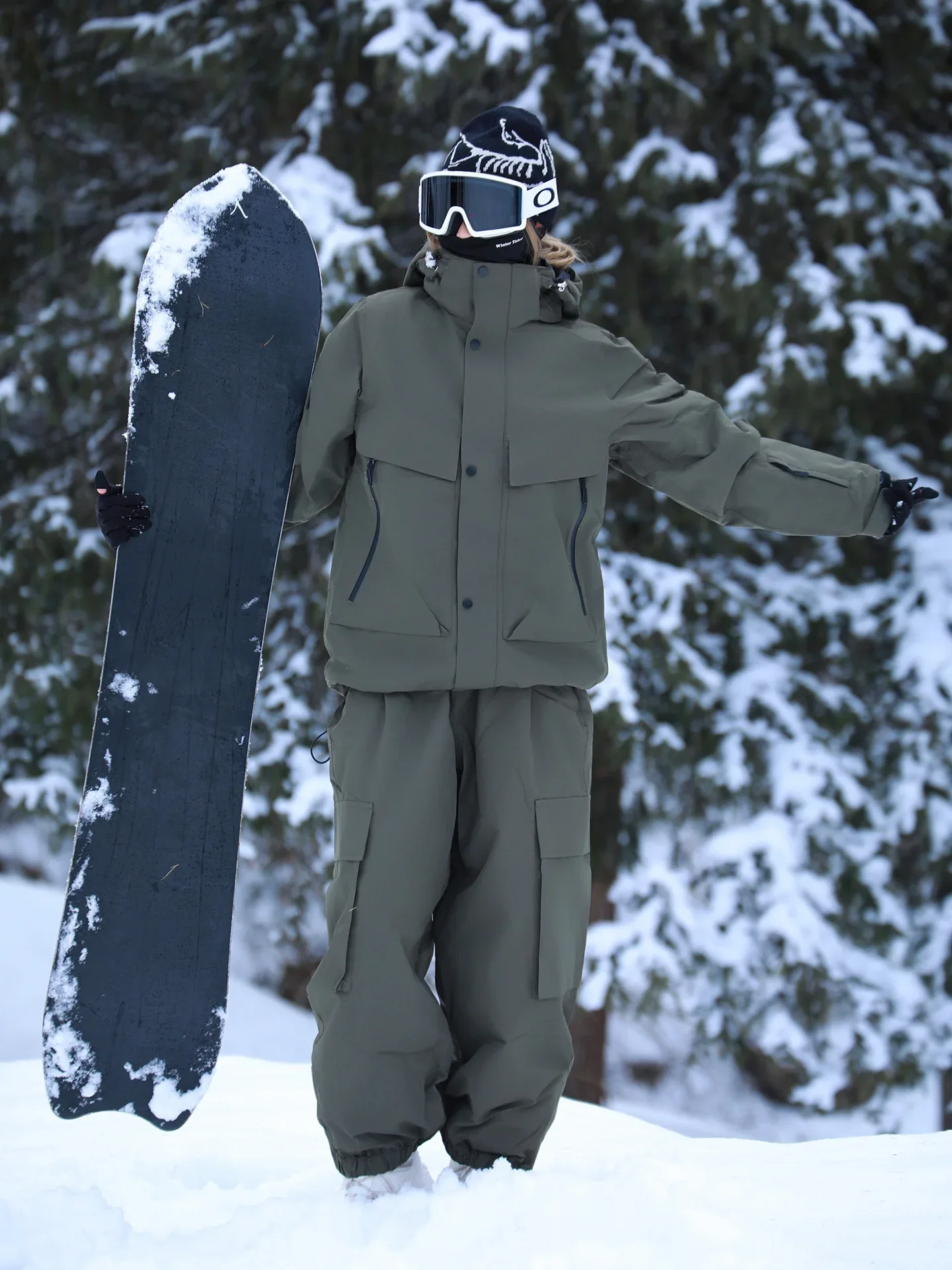 Unisex ski set in Dark Green — insulated jacket and snow pants worn on the snow