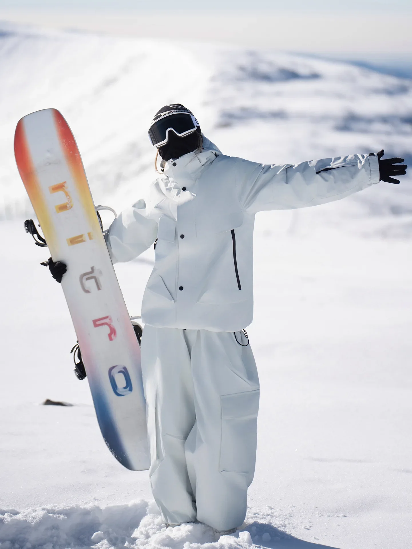 Unisex ski set in Grey White — insulated jacket and snow pants worn on the snow