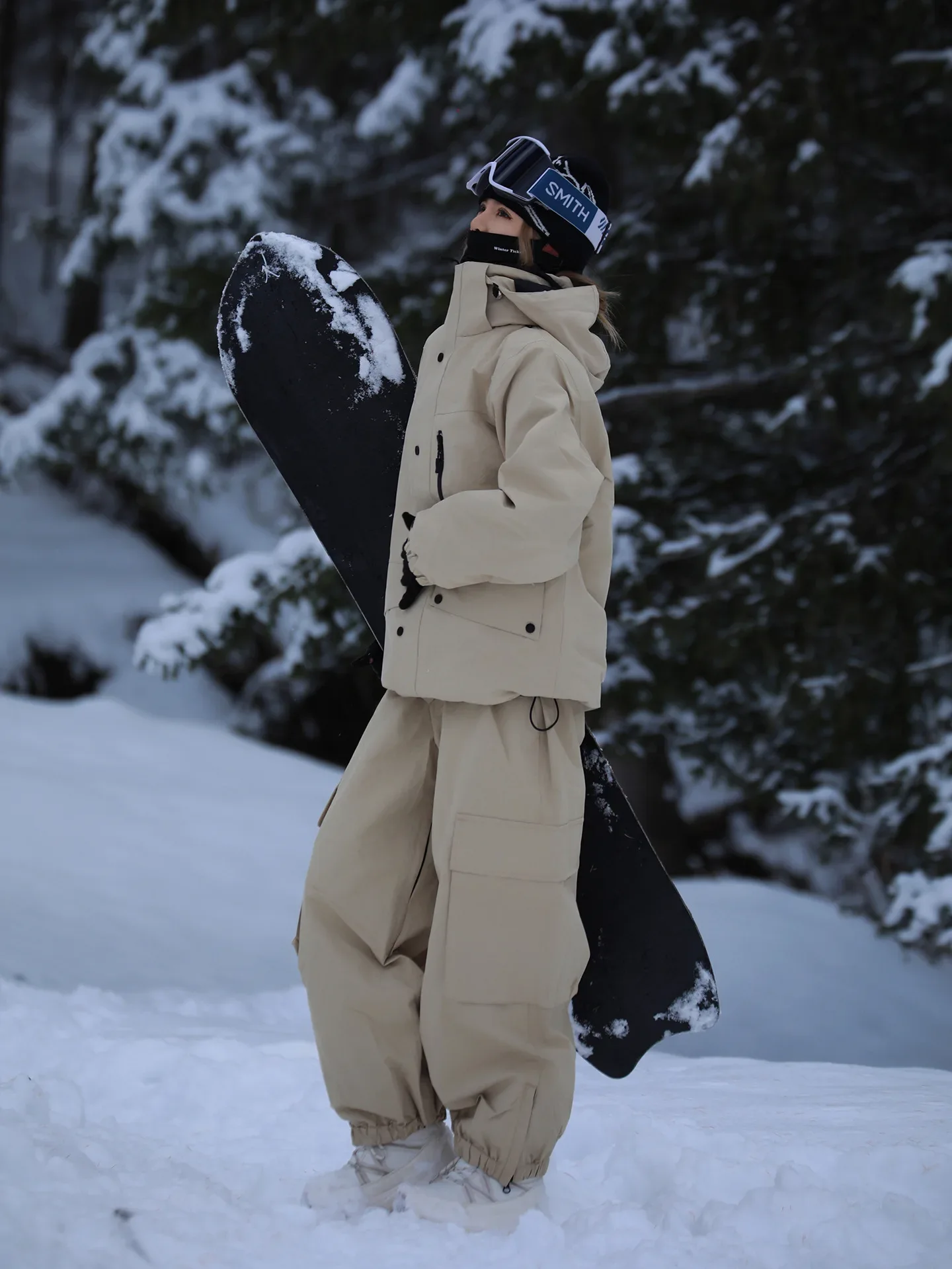 Unisex ski set in Khaki — insulated jacket and snow pants worn on the snow