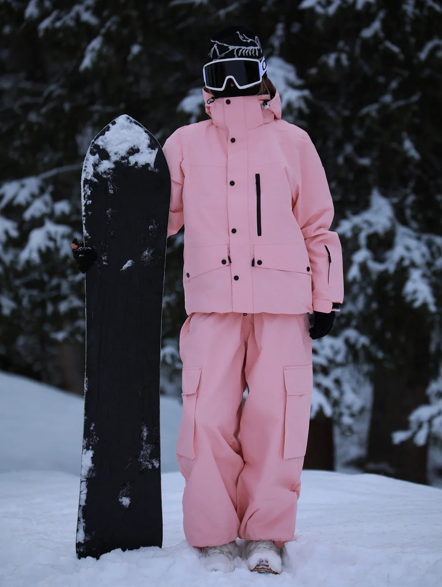 Unisex ski set in Pink — insulated jacket and snow pants worn on the snow