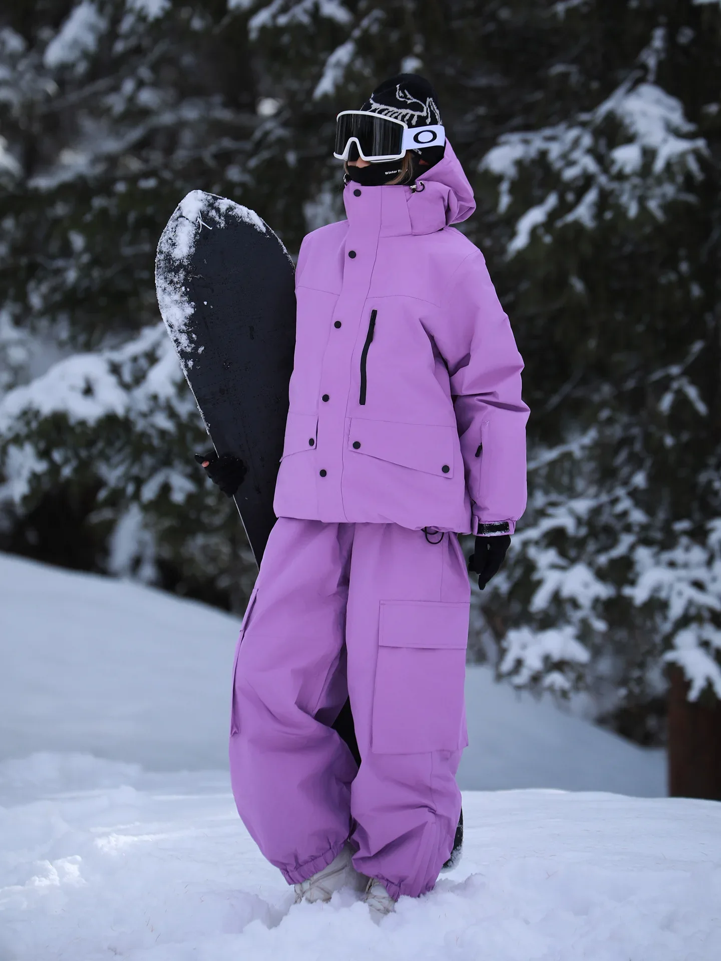 Unisex ski set in Purple — insulated jacket and snow pants worn on the snow
