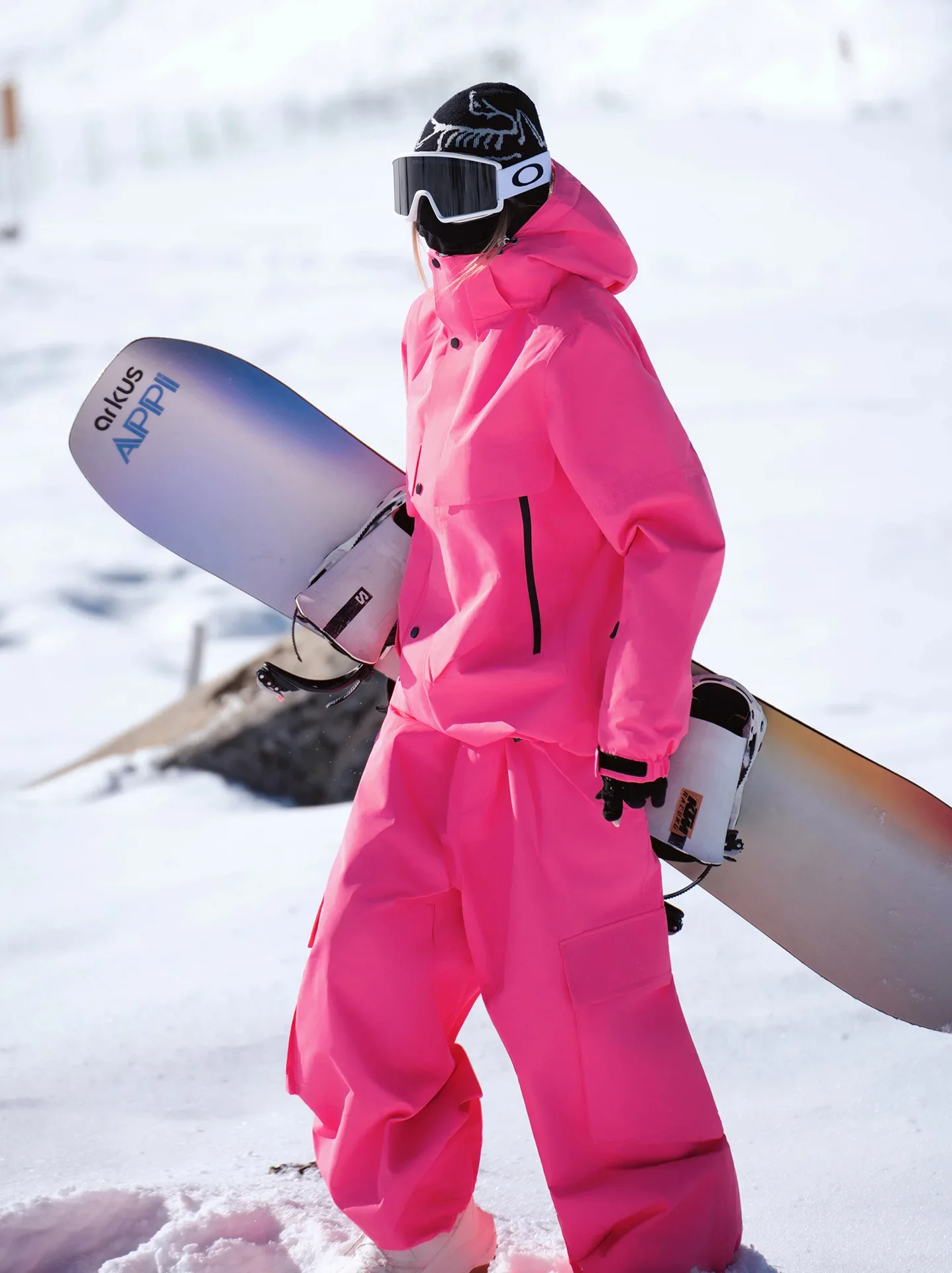 Unisex ski set in Rose Red — insulated jacket and snow pants worn on the snow
