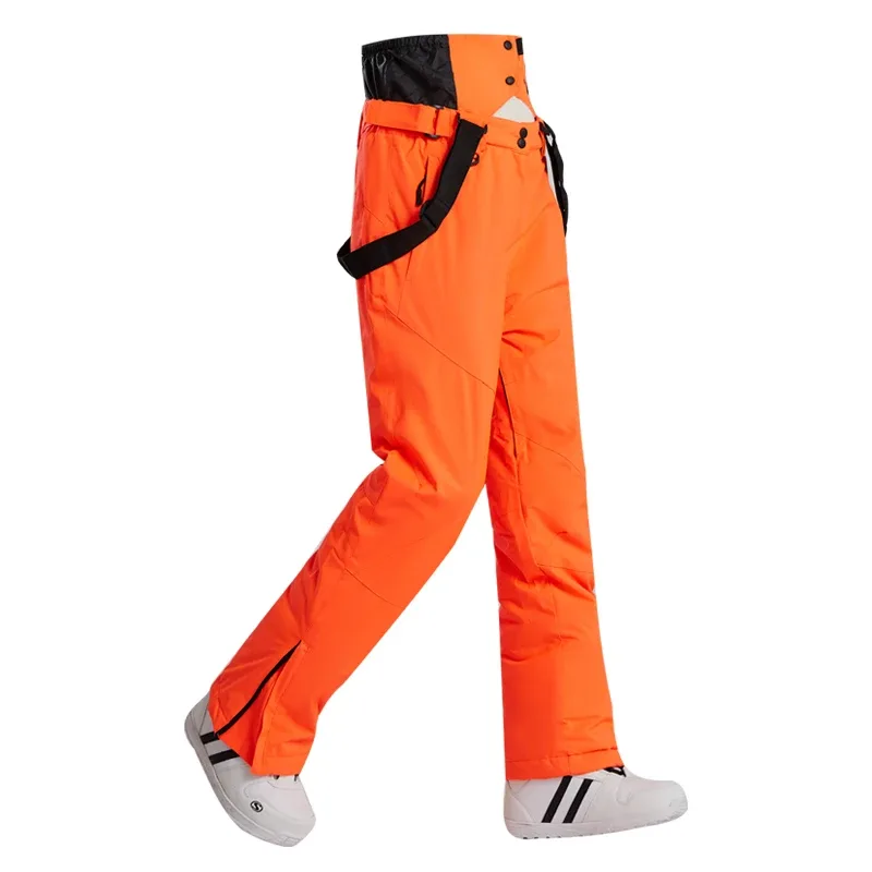 Unisex insulated ski pants in Orange — regular waist and a clean leg, worn by a model