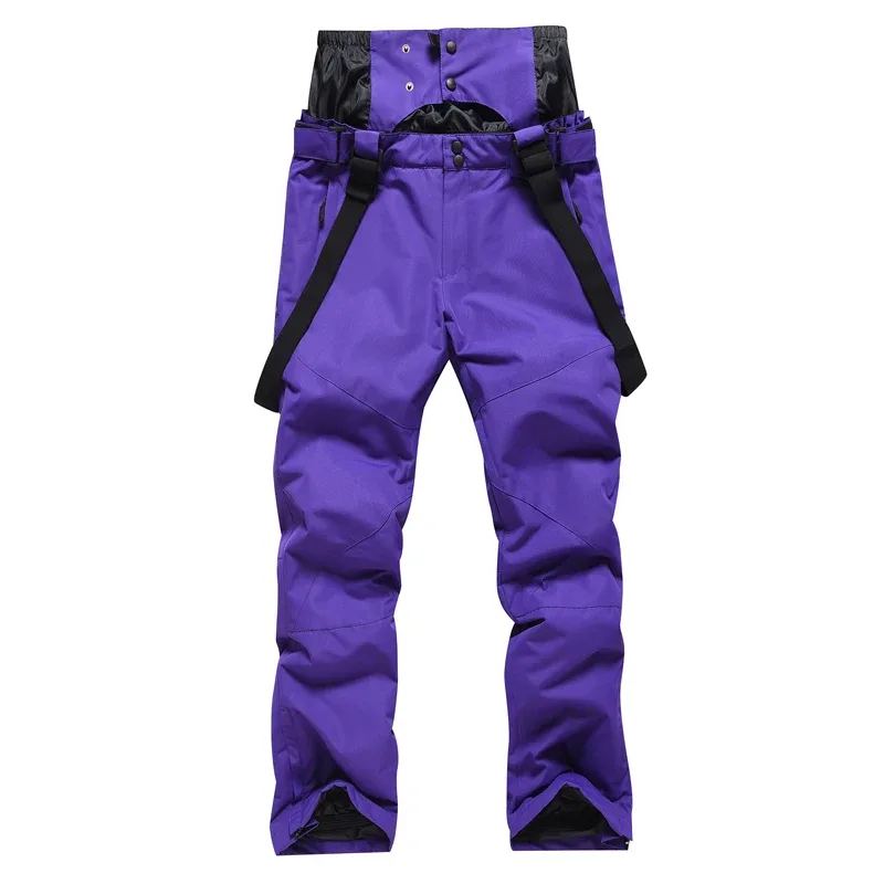 Unisex insulated ski pants in Purple — regular waist and a clean leg, worn by a model