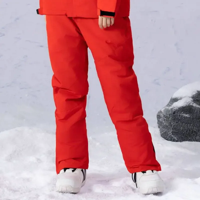 Unisex insulated ski pants in Red — regular waist and a clean leg, worn by a model