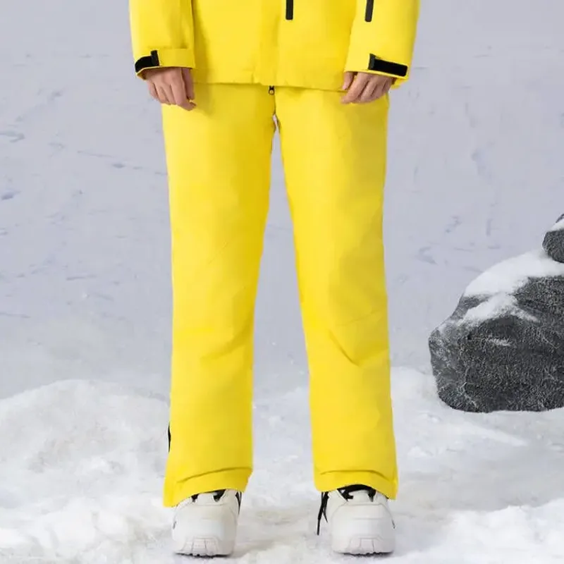 Unisex insulated ski pants in Yellow — regular waist and a clean leg, worn by a model