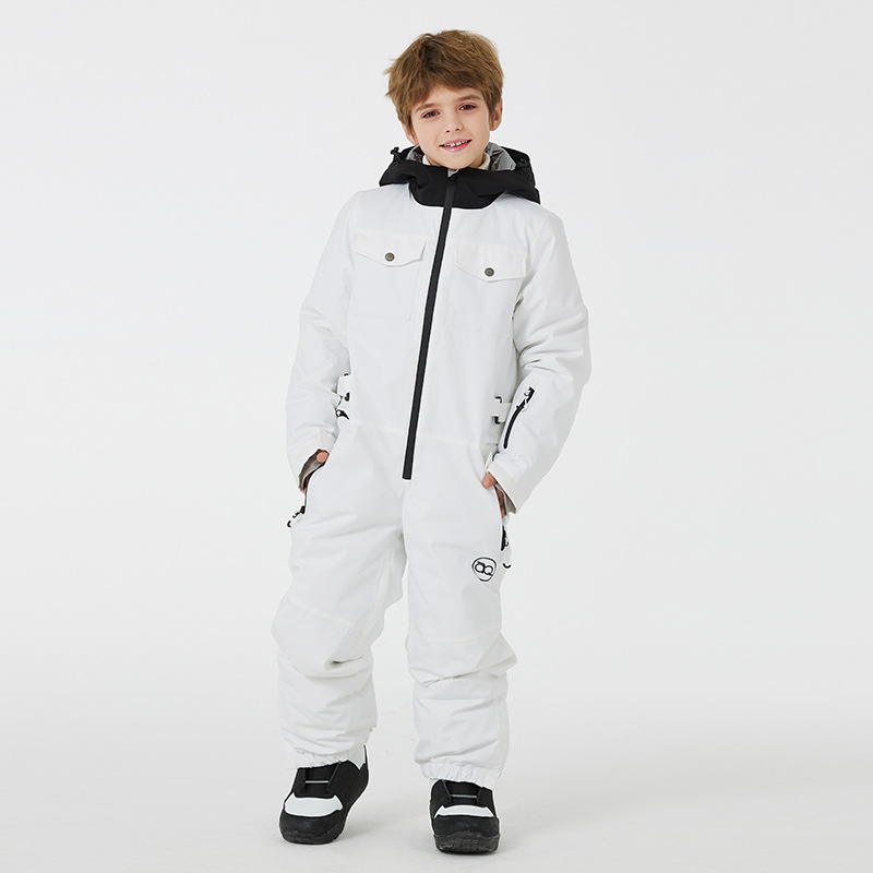 Boy wearing the white one-piece snowsuit with black-lined hood and snap-flap chest pockets, front view