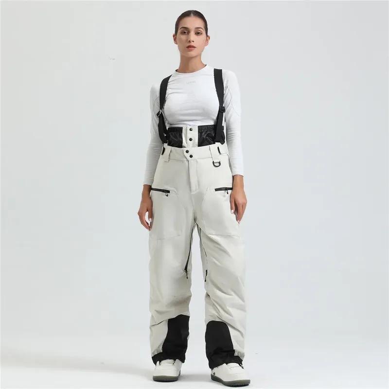 Women's ski bib pants in Beige — adjustable suspenders and a shaped fit, worn by a model