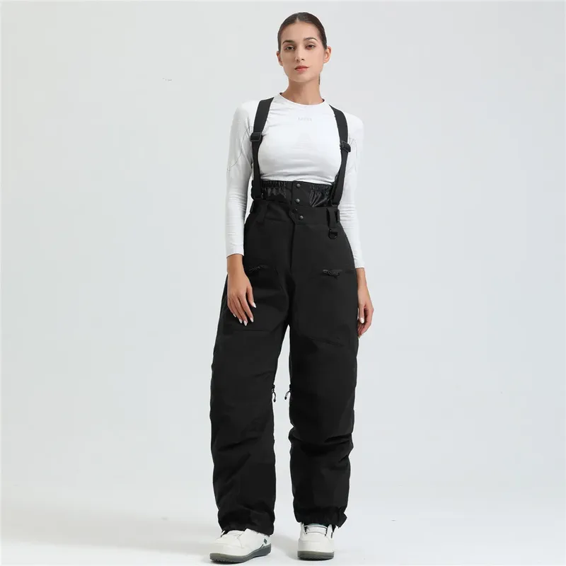 Women's ski bib pants in Black — adjustable suspenders and a shaped fit, worn by a model