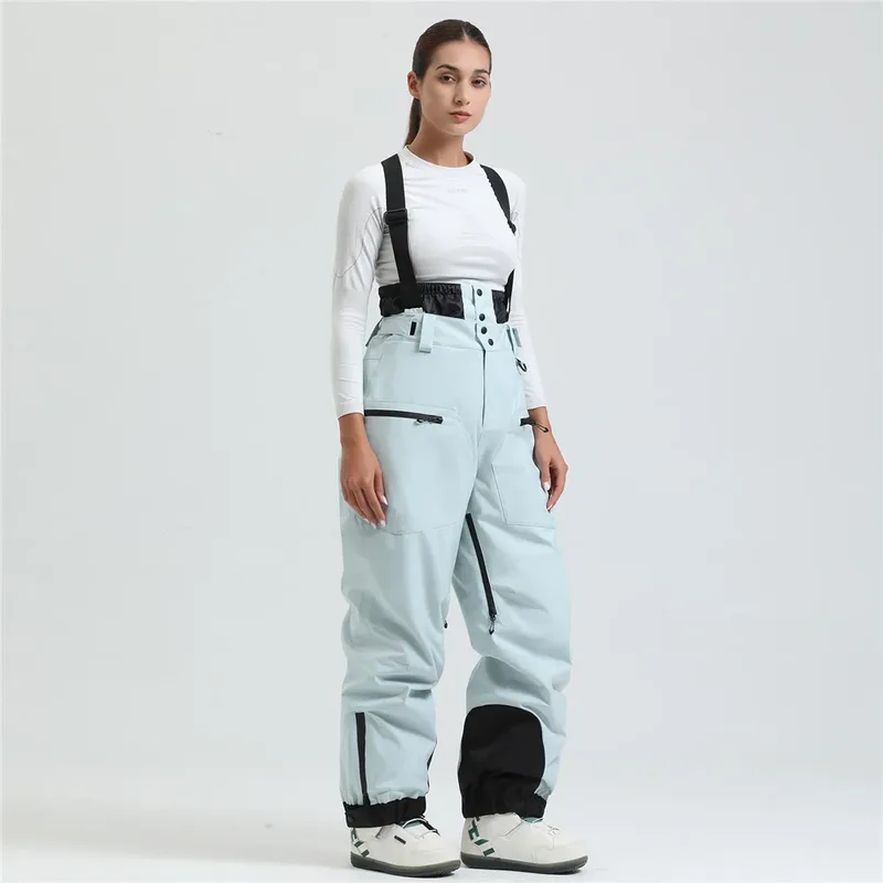 Women's ski bib pants in Light Blue — adjustable suspenders and a shaped fit, worn by a model