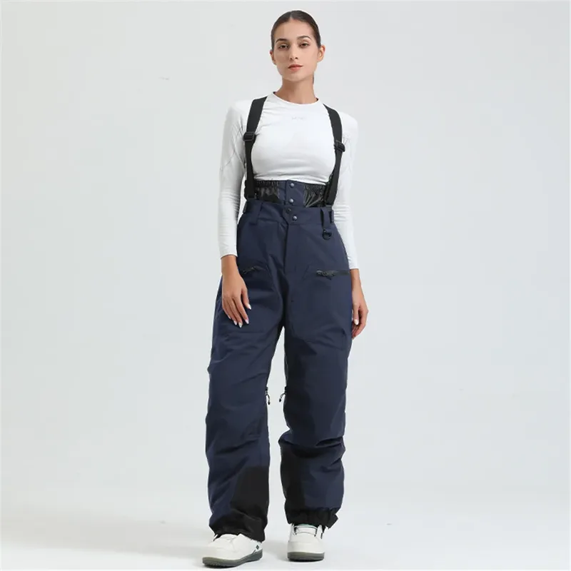 Women's ski bib pants in Navy — adjustable suspenders and a shaped fit, worn by a model