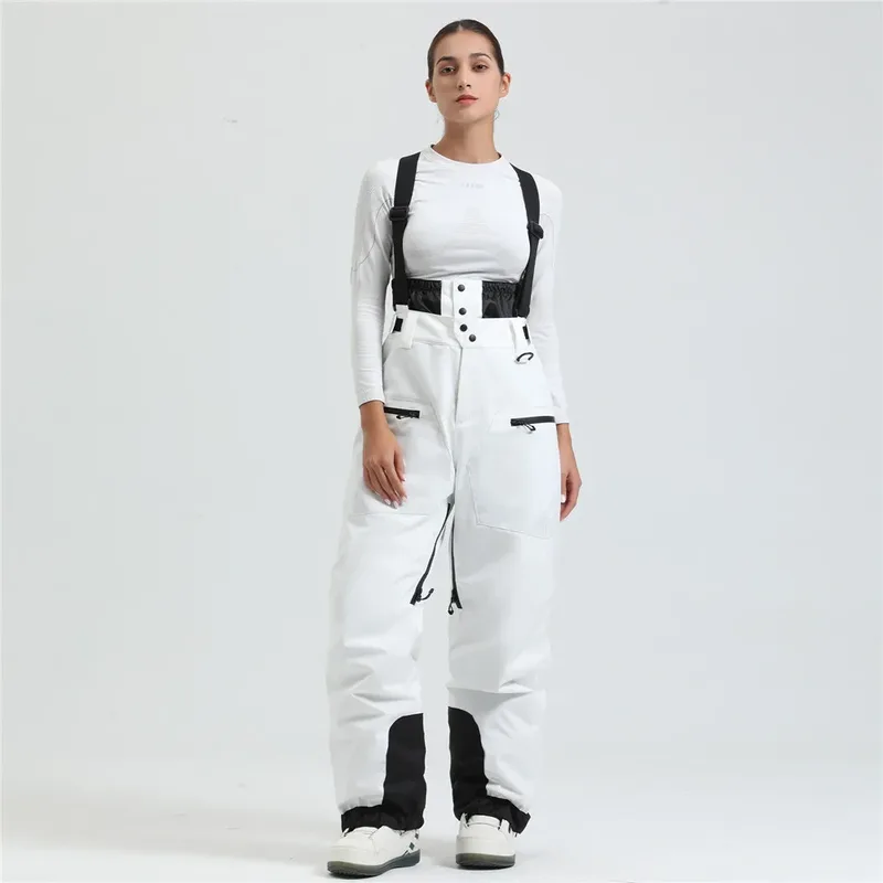 Women's ski bib pants in White — adjustable suspenders and a shaped fit, worn by a model