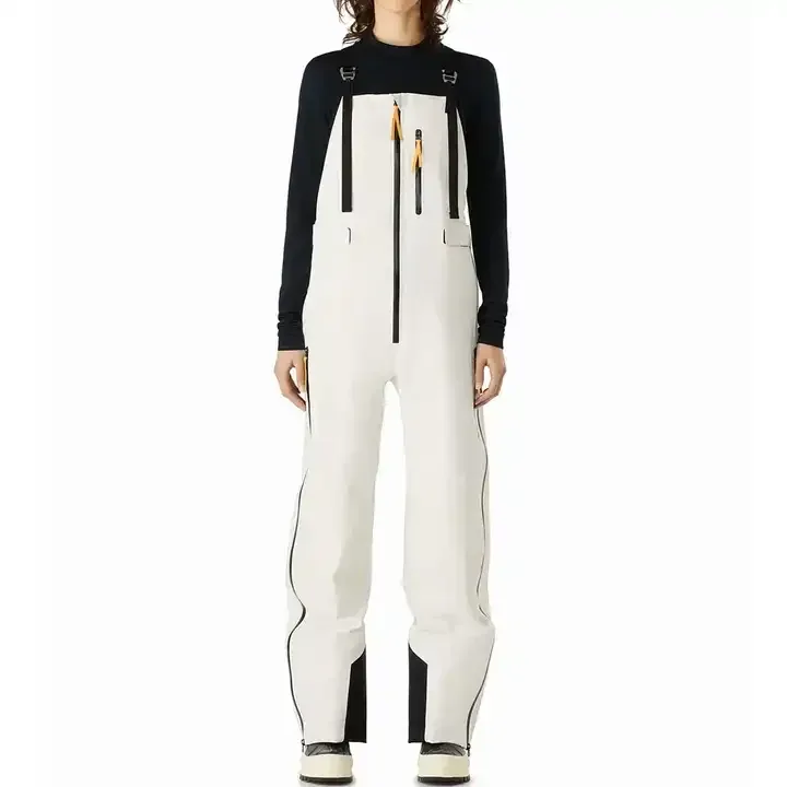Women's Ski Bib Overalls — 3 Colourways — White, worn front view with skis