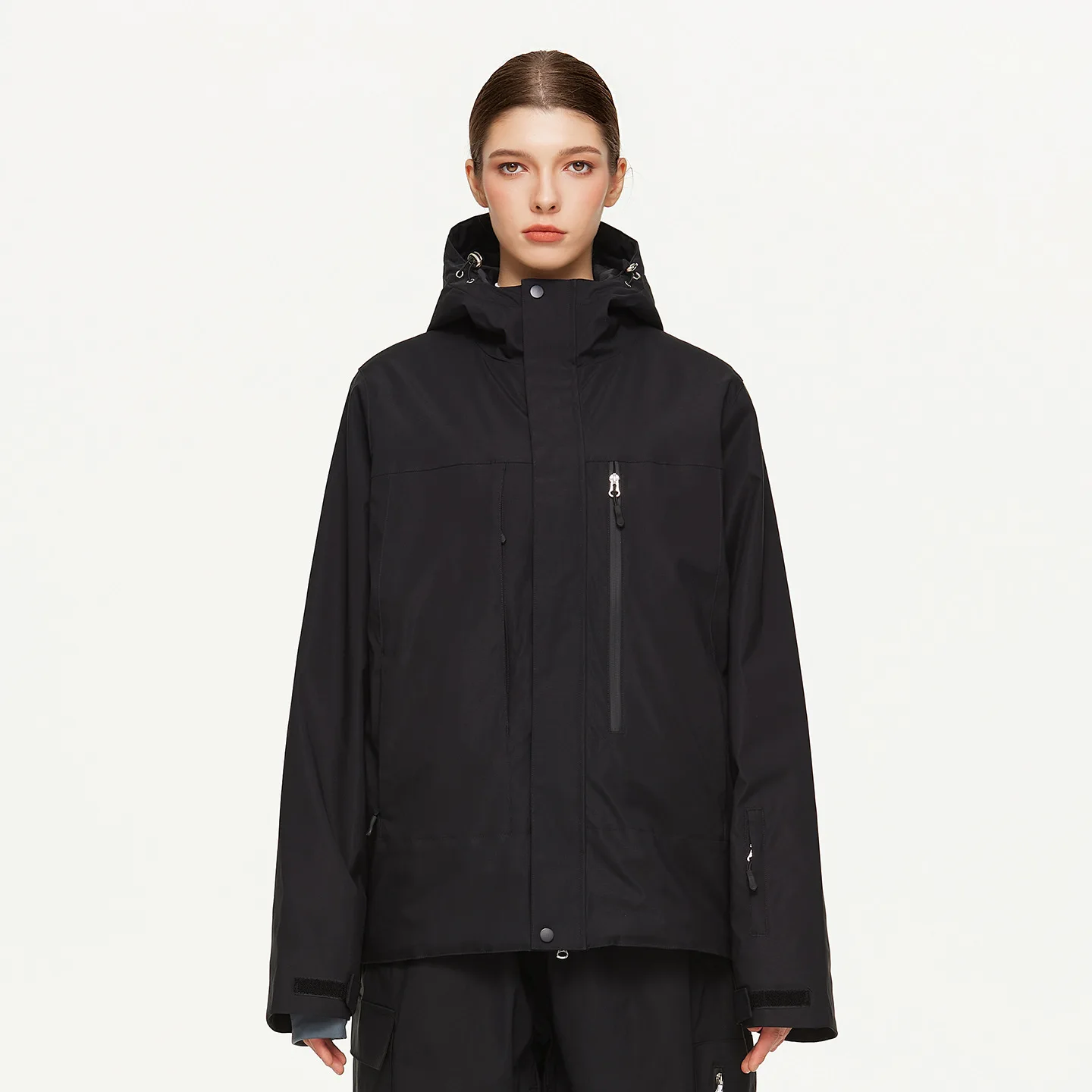 Woman wearing the women’s insulated ski jacket in Black with PP cotton fill and an attached hood