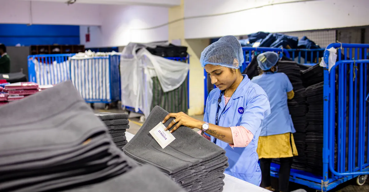 Quality inspector checking a label on folded garments